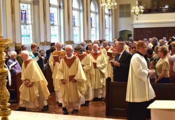 Priests process into the cathedral for the morning Mass. (Photo by John Simitz)