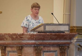 Anne Girard serves as lector for the second reading. (Photo by John Simitz)