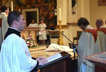 Seminarian Zachary Wehr is cantor for the Litany of Supplication (Litany of the Saints). (Photo by John Simitz)