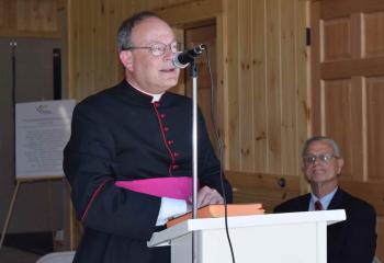 Msgr. William Baver offers a prayer at the new stable facility. (Photo by John Simitz)