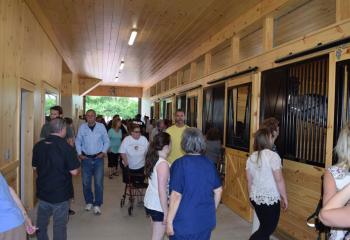 Supporters tour the first floor of the stable that features seven stalls. (Photo by John Simitz)