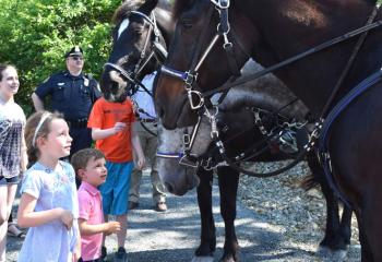 Children visit with the police horses at the facility. (Photo by John Simitz)