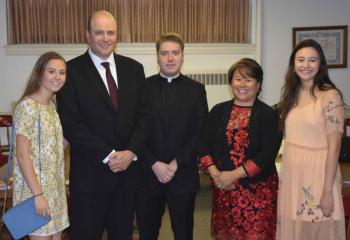 Father John Rother, center, is joined by his immediate family before his ordination, from left, his sister Gracia, his father John, his mother MarySue and his sister Melinda. (Photo by John Simitz)