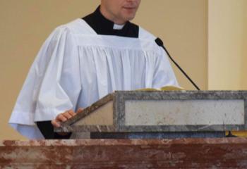 Giuseppe Esposito, diocesan seminarian, offers the First Reading. (Photo by John Simitz)
