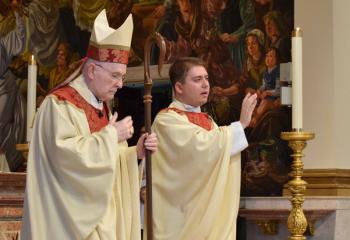 Father Rother, right, bestows the final blessing with Bishop Cullen at the conclusion of the Rite of Ordination to the Priesthood. (Photo by John Simitz)