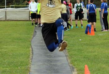 Brady White, Notre Dame of Bethlehem, leaps off the takeoff board during the long jump event at the meet.