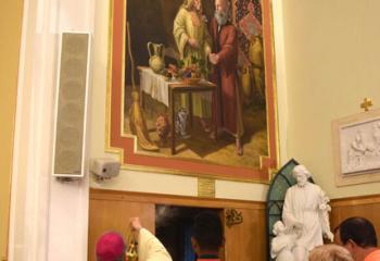 Bishop-elect Alfred Schlert incenses the mural featuring St. Anne and St. Joachim. 