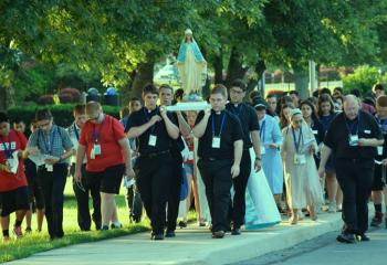 Msgr. David James, right, joins in the Rosary Procession. (Photo by John Simitz)