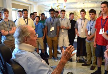 Msgr. Joseph Dooley speaks with Quo Vadis participants during their July 18 visit to Holy Family Manor, Bethlehem. (Photo by John Simitz)