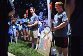 Campers pray at the station where Jesus meets his Blessed Mother. (Photo by John Simitz)