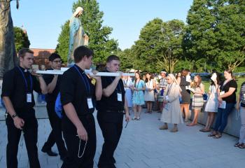 Seminarians carrying the statue of the Blessed Mother during the Rosary Procession July 16 are, from left , Aaron Scheidel, Giuseppe Esposito, Keaton Eidle and Zachary Wehr. (Photo by John Simitz)