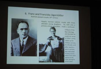 A slide displays Franz and Franziska Jägerstätter, a happily married couple who criticized Nazi ideology. Franz was executed and declared a martyr in June 2007 and beatified in October 2007.