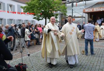 Msgr. Edward Coyle, left, former pastor of MBS, blesses the plaza with Deacon Johannes Hellenbrand.