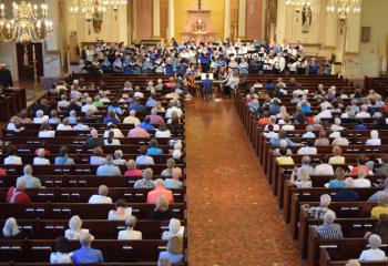More than 500 faithful enjoy the Combined Choirs’ performance of “As I Kneel Before You” by James Kilbane.