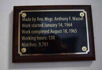 A plaque outside the chapel at HFM display the man hours, time frame and number of matches that went into the creation of the cross. (Photo by John Simitz)