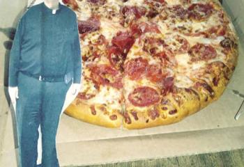 Msgr. O’Connor enjoys pepperoni pizza during one of his summer travels.