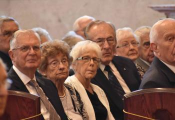 Married couples listen to the homily during the Mass.