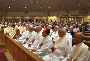Clergy and laity attend the evening Mass. 