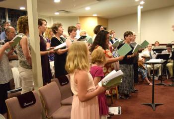 Michael Adams, director of music at St. Ignatius Loyola, directs a combined choir at the Mass.