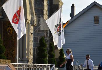 The Diocesan flag and a flag bearing Bishop Alfred Schlert’s coat of arms hang at the entrance of St. Joseph, Jim Thorpe. “The early fathers of the Church commented that where the Bishop is, there is the Church,” said Father Francis Baransky.