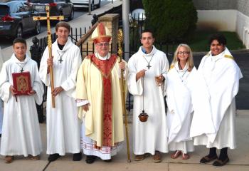 Bishop Alfred Schlert, center, is greeted by altar servers, from left: Anthony Soberick, Immaculate Conception, Jim Thorpe; Noah Snisky, St. Joseph, Jim Thorpe; Zach Mauro, St. Peter the Fisherman, Lake Harmony; Brianna Snisky, St. Joseph; and Rianna Mohammed, St. Peter the Fisherman.
