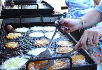 Potato pancakes are prepared for noshing. (Photo by John Simitz)
