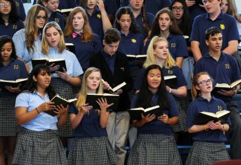The school’s choir sings during the Mass. (Photo by Ed Koskey)
