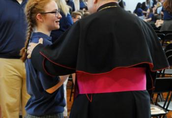 Bishop Schlert talks with senior Shea Elliot after celebrating his first school Mass as Bishop of Allentown. (Photo by Ed Koskey)