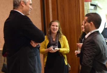 National presenter Bill Donaghy, left, speaks with Jen Shankweiler and Ryan Baptista at the presentation.