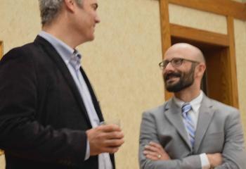Bill Donaghy, left, chats with William Hamant, assistant professor of theology at DeSales University, Center Valley at the event.