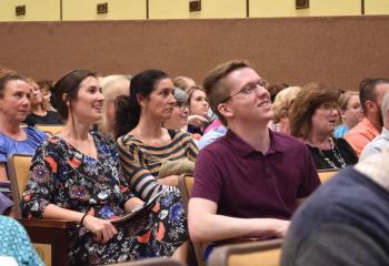 Teachers listen to the keynote address discussing becoming more welcoming to immigrants.