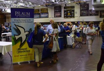 Educators tour the more than 50 exhibits and vendors in the school gymnasium.