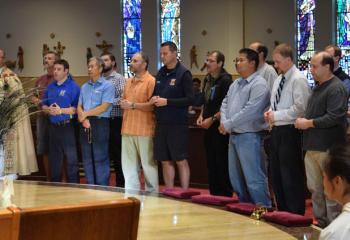 Men join together to pray a decade of the rosary at St. Elizabeth. (Photo by John Simitz)