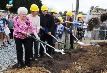 Turning over dirt to clear the way for construction of the new parish center are, from left, Joan Frisch, Jodi Mariano, Father Joseph Tobias, Morgan Halldorson, Blaise Hunt, Stephen Keppel, Ed Perusse and Christine Bruce. 