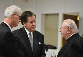 Bishop William Murphy, right, greets Attorney Joseph Zator, left, and Judge Joseph Leeson.
