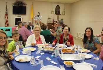 Faithful observe the 100th anniversary of Fatima with a special meal at St. Patrick. (Photo by Debbie Walker)