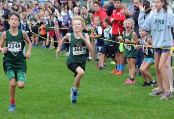 Henry Parrish of St. Ann, Emmaus, left, and Aiden Van Wert of St Jane give it their all as they near the finish of the third and fourth grades boys’ race.