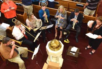 The brass choir plays a musical selection before Mass. 