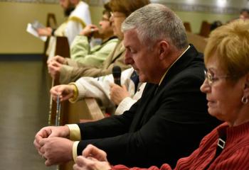 Praying a decade of the rosary are, from back, Father Christopher Zelonis, Georgine Walters. Anne Gemnell, Sheila Berezowski (hidden), Christopher Schwartz and Marlene Doyle. 