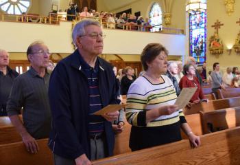 Parishioners of St. John the Baptist pray together as they kick off “One Community: Connecting, Reaching and Building in Mary, Mother of Peace.”