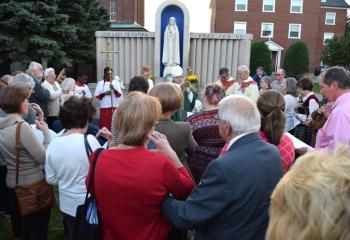 Parishioners receive a blessing from Bishop Schlert during the blessing of the newly refurbished Our Lady of Fatima grotto.