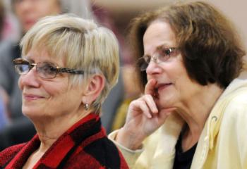 Rita Hocking, left, and Maureen Bozzuto listen during the discussion focusing on Marian prayers and the mysteries of the rosary.