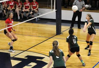 Elizabeth Williams (No. 28), right, volleyball player for St. Anne, Bethlehem, attacks the ball during the team’s match against St. Thomas More.