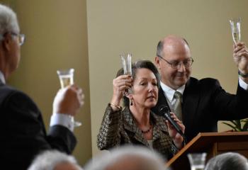 Randy and Paul Waterman, co-chairpersons of the Building Campaign, make a toast celebrating the completion of the new $2.2 million center.