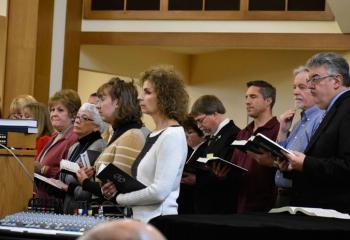 The parish choir sings a hymn during the Mass.