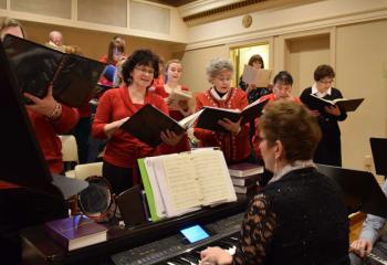 Members of the Cathedral Choir, directed and accompanied by Beverly McDevitt, sing before Mass.
