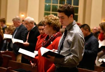 Parishioners lift their voices in song during the entrance hymn.