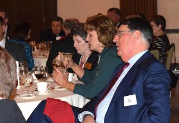 Guests listen to Bishop Alfred Schlert address the group as the evening’s featured speaker.