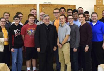Bishop of Allentown Alfred Schlert, center, welcomes young men and diocesan seminarians back after their camp experience at “Do Whatever He Tells You.” Also reuniting with the young men are, Father Kevin Lonergan, right, assistant pastor of the Cathedral of St. Catharine of Siena, Allentown; Father Mark Searles, fifth from right, chaplain, Allentown Central Catholic High School; and Msgr. David James, fourth from left, diocesan vicar general and director of the Office of Vocations.