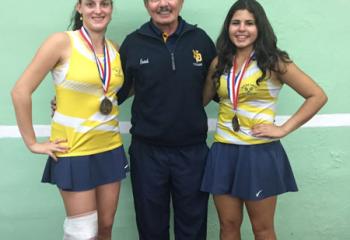 Girls’ tennis District XI AA Doubles champions Logan Lencheski, left and Emma Anmolsingh of Notre Dame High School flank coach Tom D’Angelo. (Photo courtesy of Cheryl Fenton)